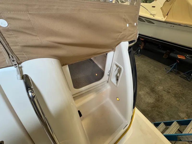 Slide: The Image of 2004 Tiara Yachts 3600 Sovran, rear deck view with beige canopy and storage area. - 3