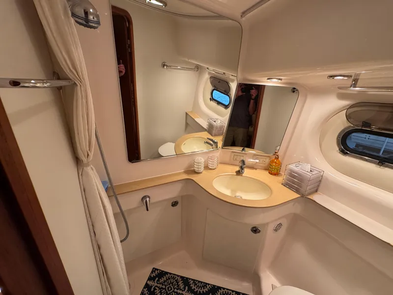 Slide: The Image of 2004 Tiara Yachts 3600 Sovran bathroom with sink, mirror, and porthole window. - 30