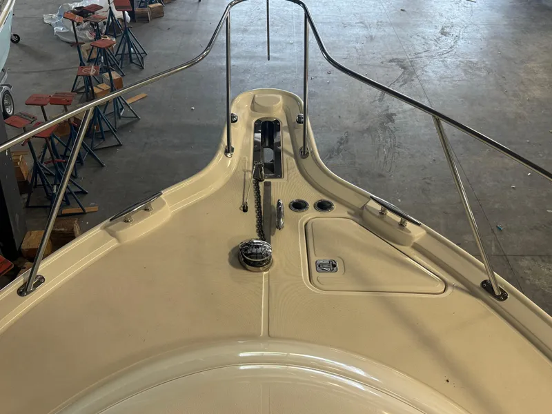 Slide: The Image of 2004 Tiara Yachts 3600 Sovran bow with anchor and railings in a warehouse setting. - 32