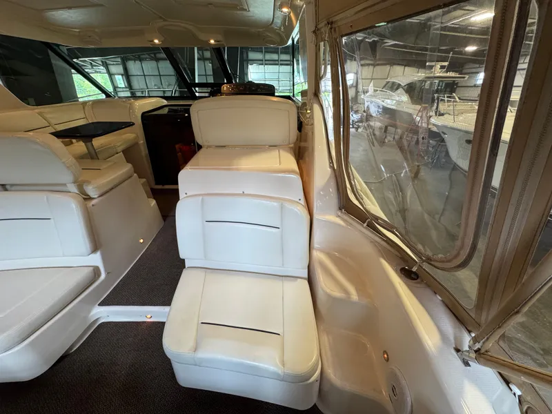Slide: The Image of 2004 Tiara Yachts 3600 Sovran interior with white seating and large windows. - 4