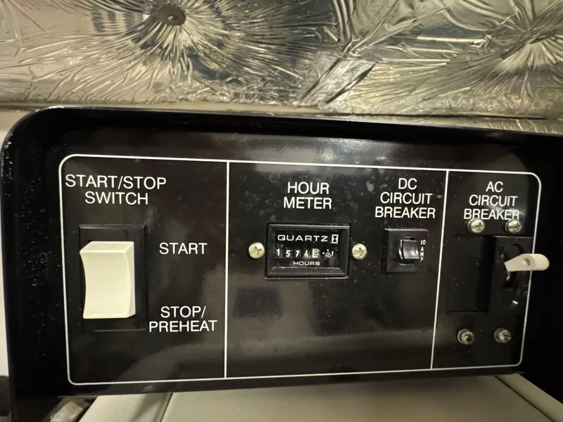 Slide: The Image of Control panel of a 2004 Tiara Yachts 3600 Sovran with hour meter and circuit breakers. - 41