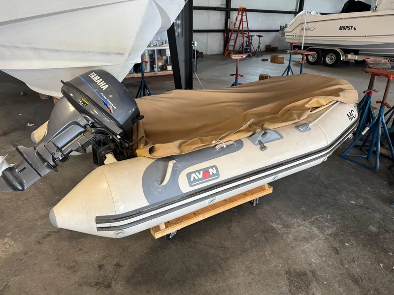 Slide: The Image of Inflatable boat with Yamaha motor in a storage facility, near a Tiara Yachts 3600 Sovran. - 42
