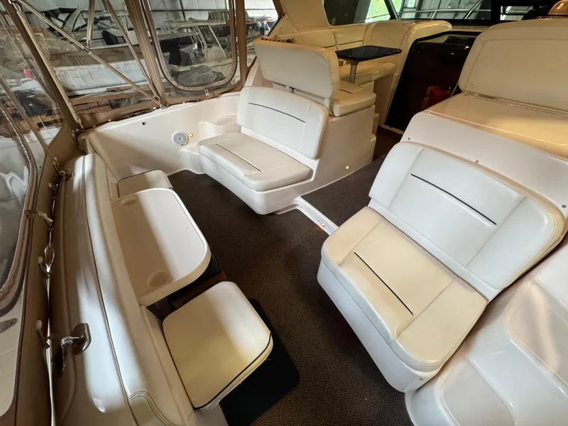 Slide: The Image of 2004 Tiara Yachts 3600 Sovran interior with white seating and carpeted flooring. - 5