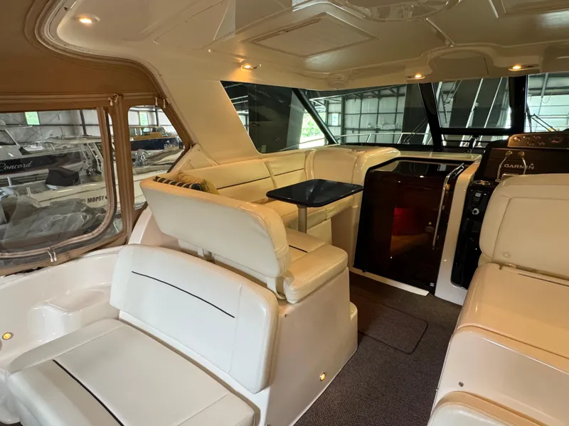 Slide: The Image of Interior of 2004 Tiara Yachts 3600 Sovran with white seating and a small table. - 6