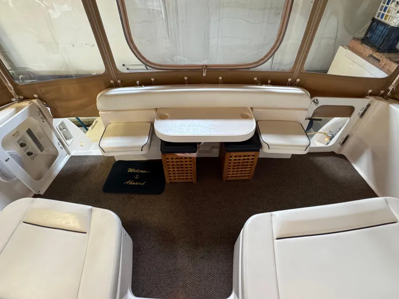Slide: The Image of 2004 Tiara Yachts 3600 Sovran interior with seating, table, and carpeted floor. - 7