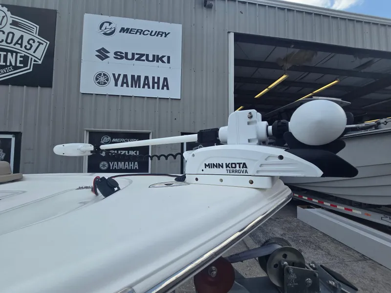 Slide: The Image of 2021 Sea Pro 228 Bay with Minn Kota Terrova motor at a marine dealership. - 16