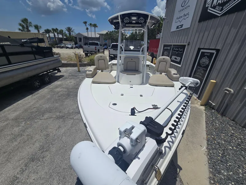Slide: The Image of 2021 Sea Pro 228 Bay boat with seating, parked outdoors under a clear sky. - 4