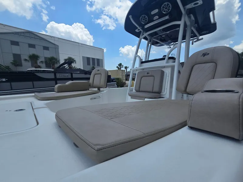 Slide: The Image of 2021 Sea Pro 228 Bay boat with beige seating, under a blue sky. - 5
