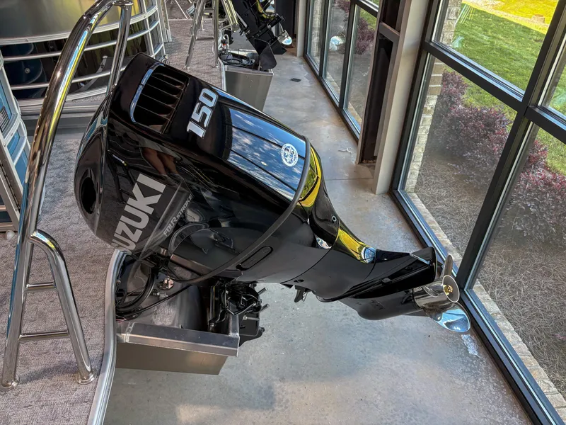 Slide: The Image of Outboard motor on a 2025 Trifecta 22 RF LE boat, displayed indoors. - 12