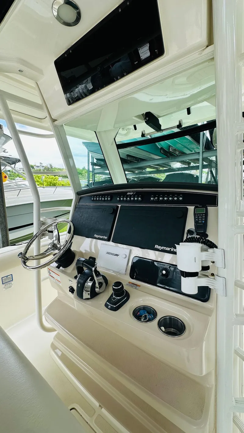 Slide: The Image of 2020 Boston Whaler 330 Outrage helm with advanced navigation and control systems. - 10