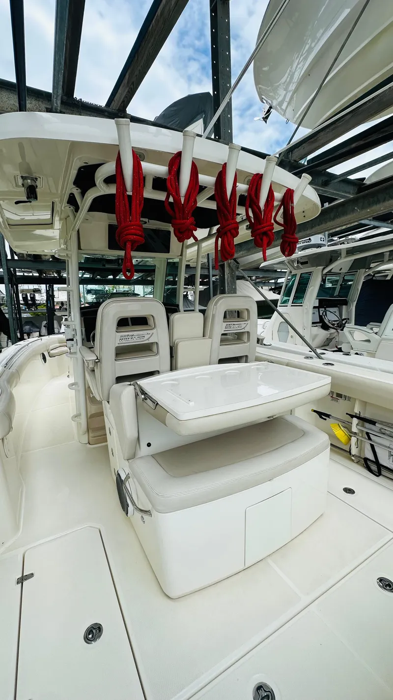 Slide: The Image of 2020 Boston Whaler 330 Outrage boat interior with seating and fishing rod holders. - 12