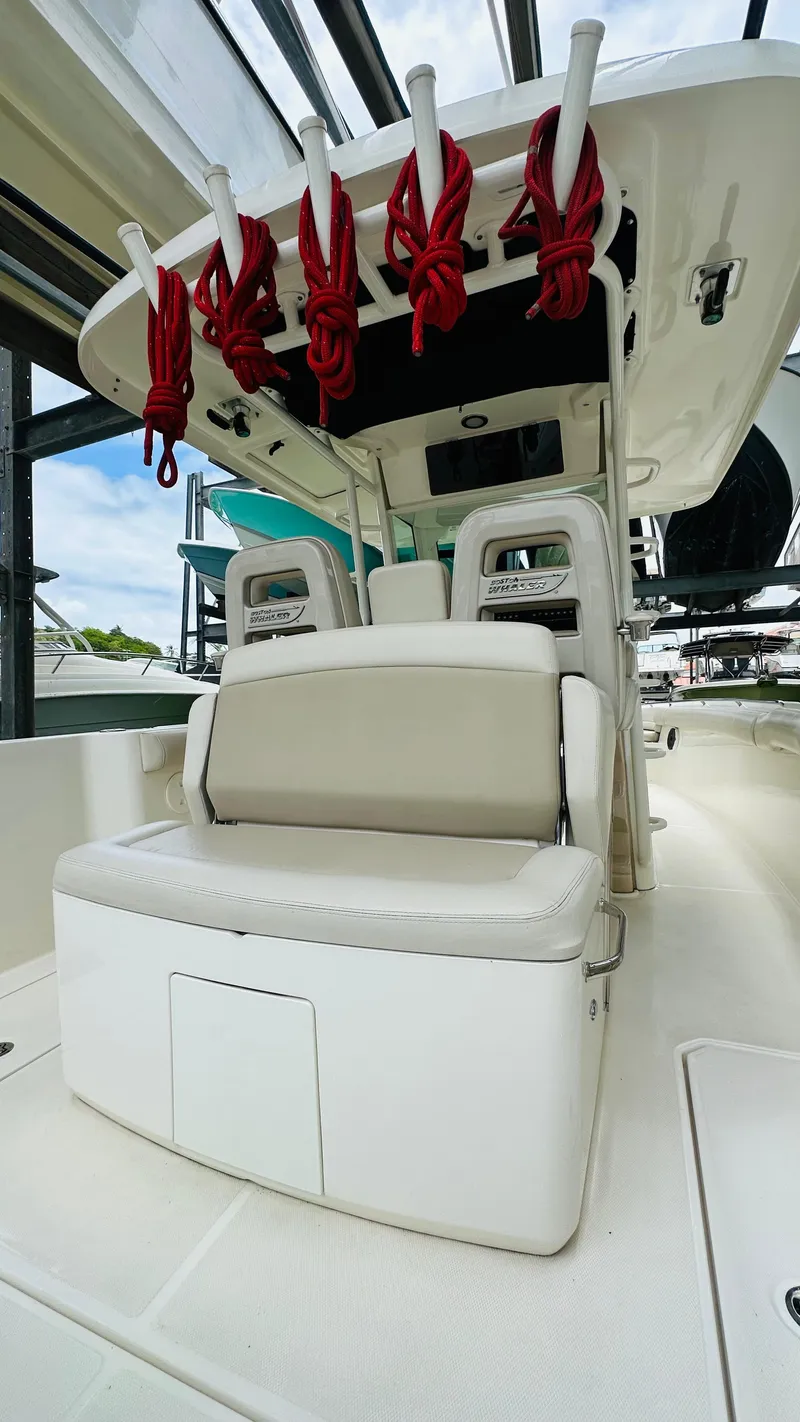 Slide: The Image of 2020 Boston Whaler 330 Outrage interior with seating and rod holders. - 13