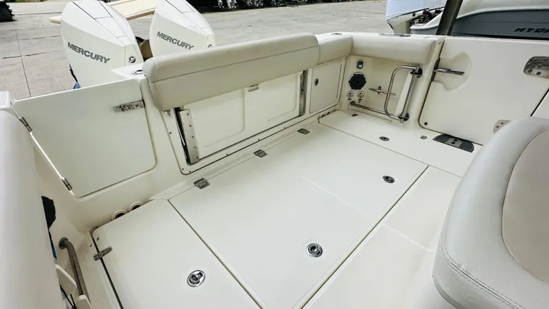 Slide: The Image of 2020 Boston Whaler 330 Outrage boat deck with Mercury engines, featuring spacious seating and storage. - 15