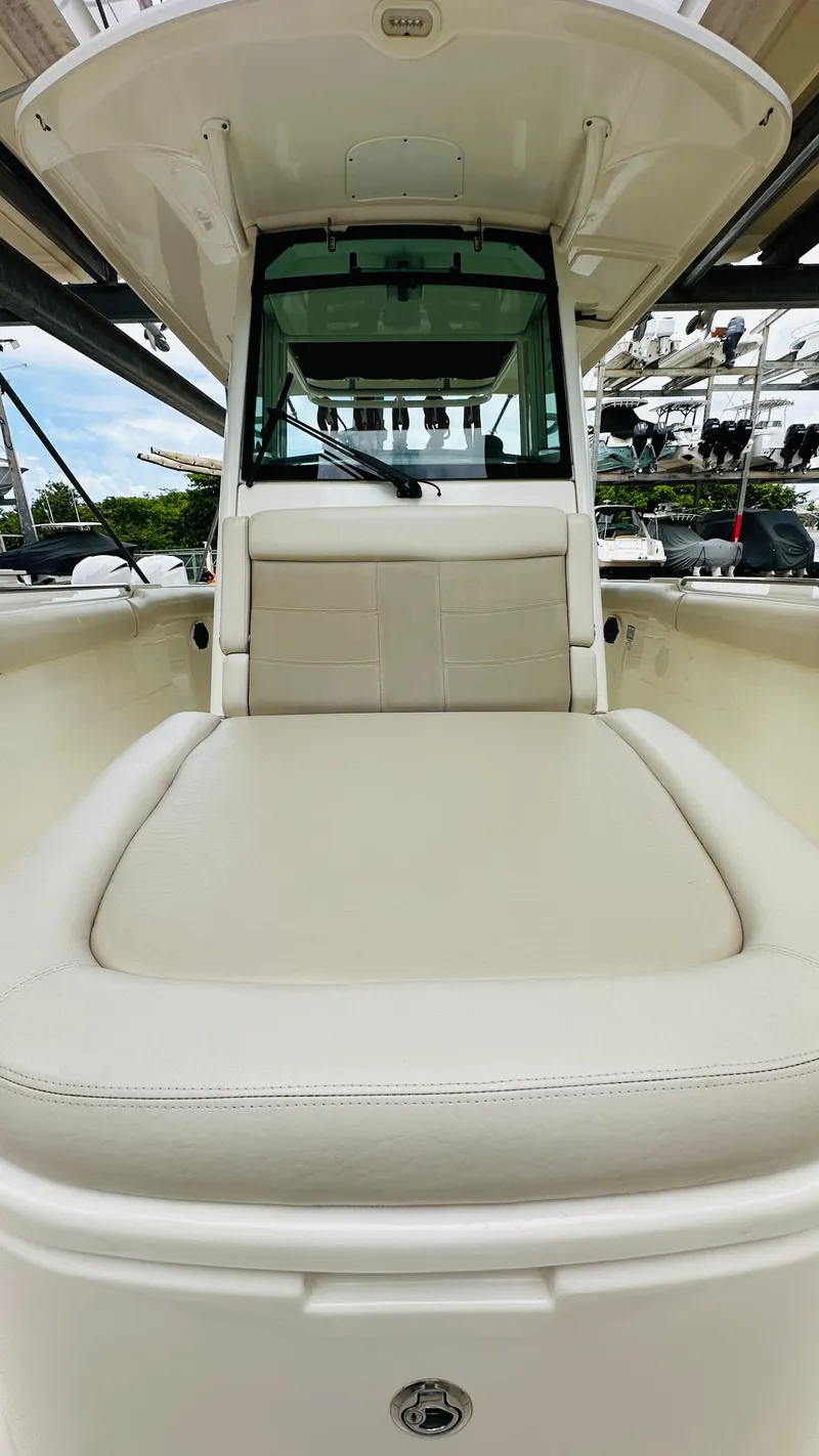 Slide: The Image of 2020 Boston Whaler 330 Outrage boat with cushioned seating and sleek design. - 4