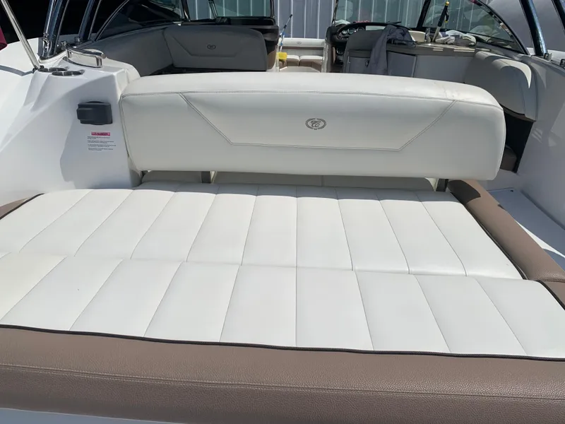 Slide: The Image of 2014 Cobalt 302 boat interior with white and brown seating. - 10