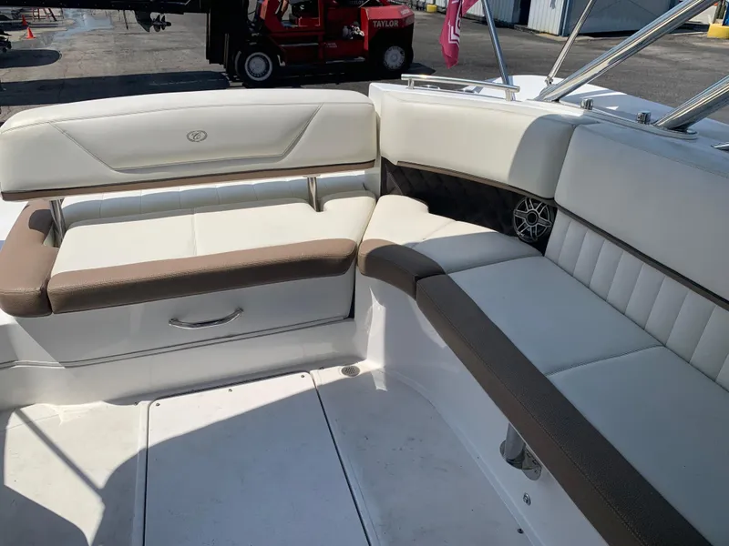 Slide: The Image of 2014 Cobalt 302 boat interior with white and brown seating. - 11