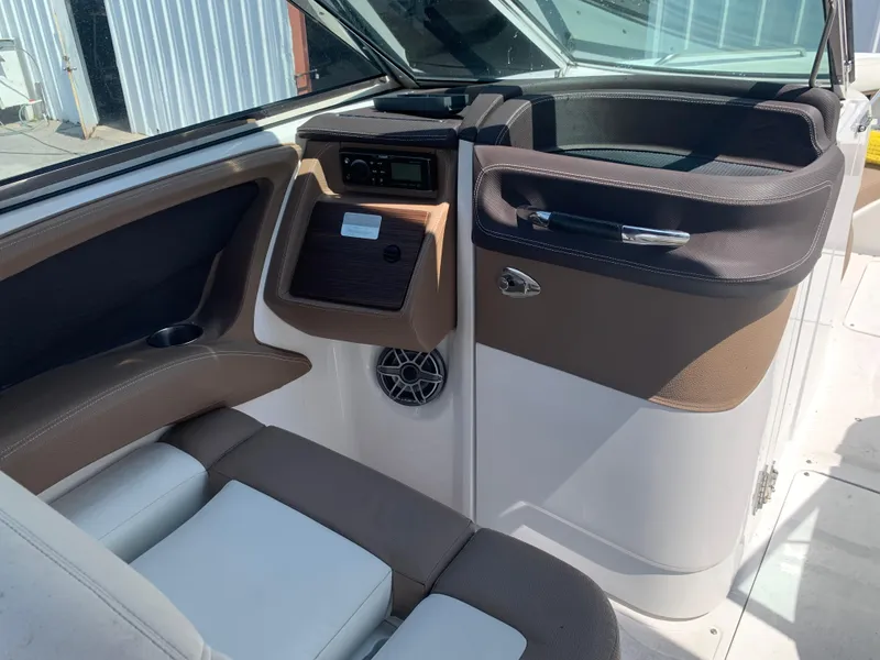 Slide: The Image of Interior of a 2014 Cobalt 302 boat, featuring seating and control panel. - 15