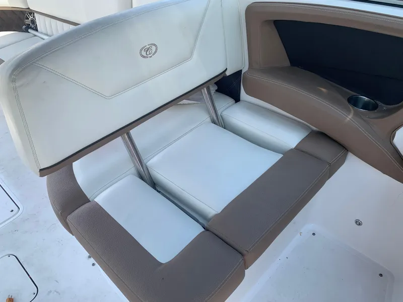 Slide: The Image of 2014 Cobalt 302 boat interior seating with beige and white upholstery. - 17