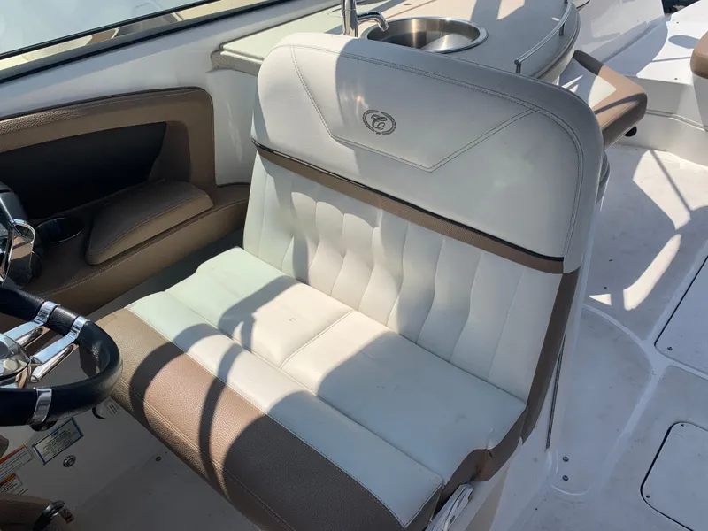 Slide: The Image of 2014 Cobalt 302 boat interior with white and brown seating. - 19