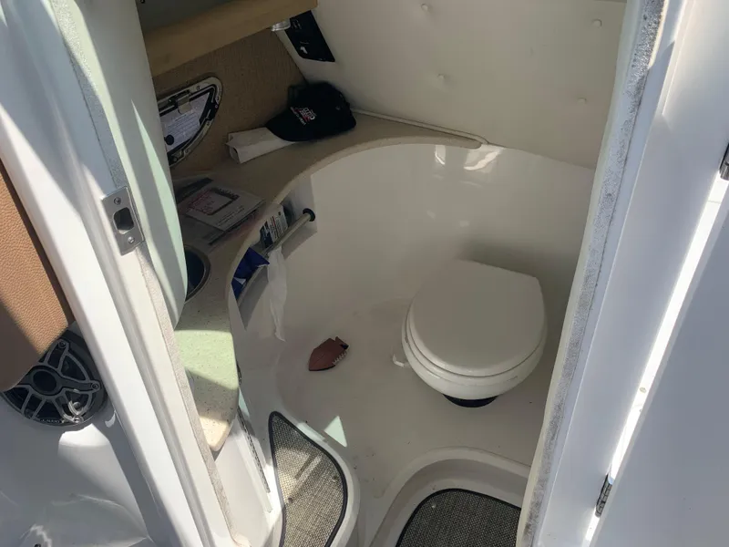 Slide: The Image of Interior of a 2014 Cobalt 302 boat bathroom with toilet and storage. - 20