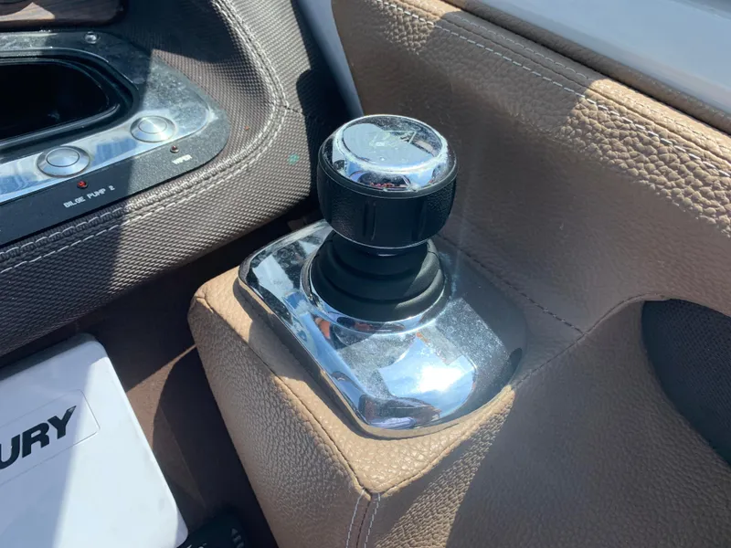 Slide: The Image of Chrome joystick control on 2014 Cobalt 302 boat, surrounded by brown leather. - 21