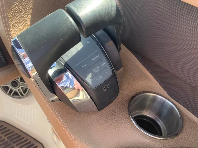 Slide: The Image of Throttle control and cup holder on 2014 Cobalt 302 boat interior. - 22