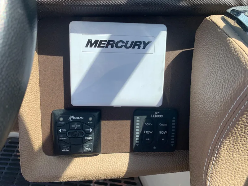 Slide: The Image of Control panel of a 2014 Cobalt 302 boat featuring Mercury and Lenco systems. - 23