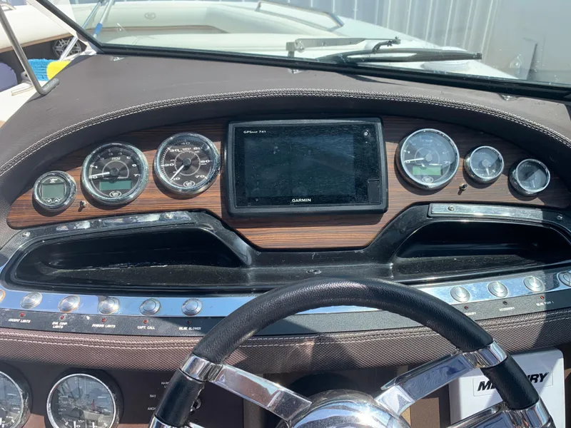 Slide: The Image of Dashboard of a 2014 Cobalt 302 boat with gauges and a central display. - 24