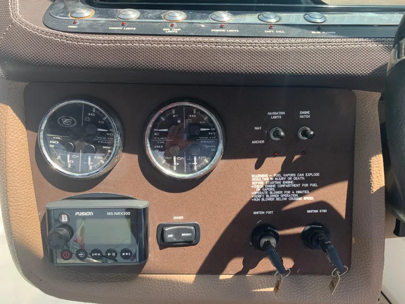 Slide: The Image of Dashboard of a 2014 Cobalt 302 boat with gauges and controls. - 25