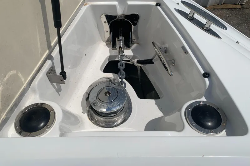 Slide: The Image of Anchor compartment of a 2014 Cobalt 302 boat with chain and winch. - 29