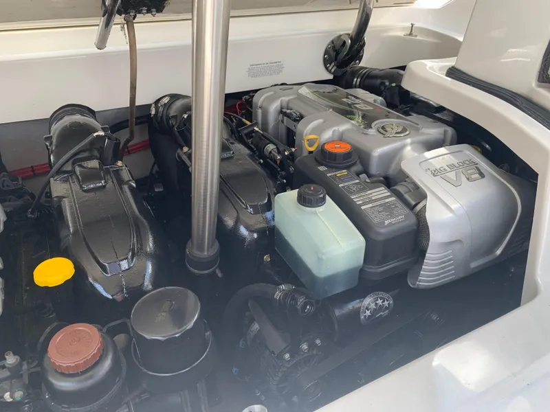 Slide: The Image of Engine compartment of a 2014 Cobalt 302 boat, showcasing detailed components and layout. - 31