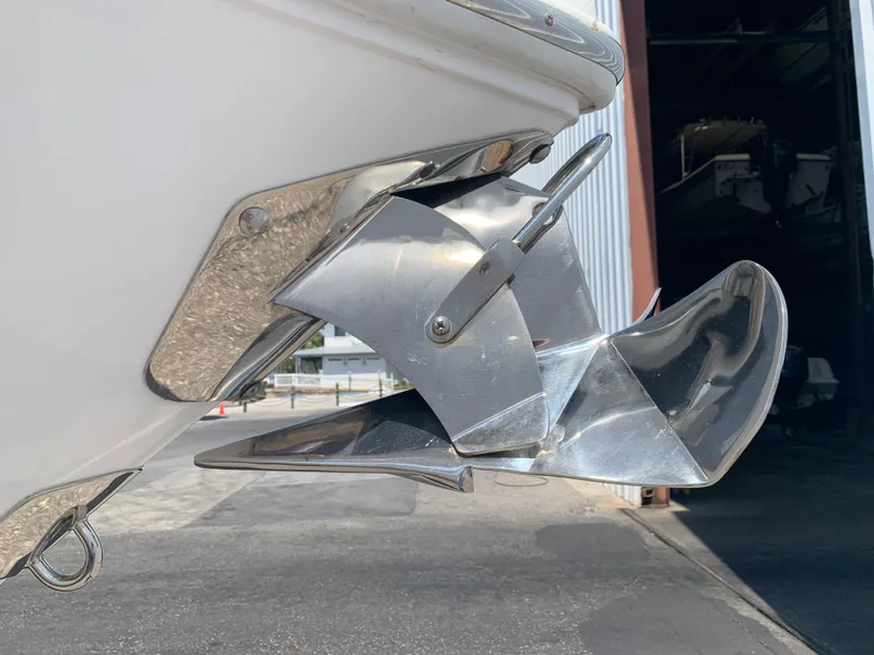 Slide: The Image of Stainless steel anchor on a 2014 Cobalt 302 boat, docked near a warehouse. - 4
