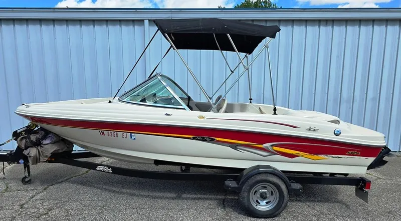 Slide: The Image of 2003 Sea Ray 176 SRX BR boat with trailer, featuring a red and white design. - 16