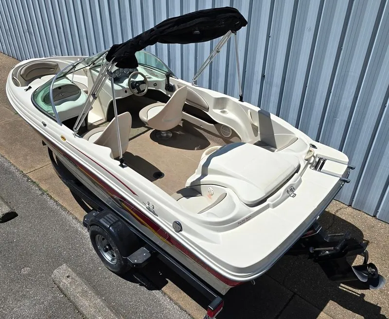 Slide: The Image of 2003 Sea Ray 176 SRX BR boat on trailer, white exterior, open bow design. - 2