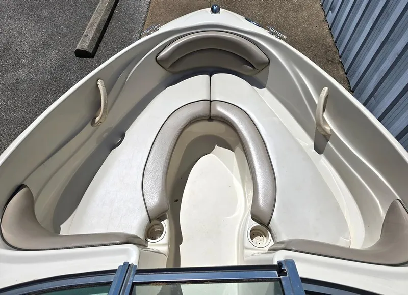 Slide: The Image of 2003 Sea Ray 176 SRX BR boat interior with cushioned seating and cup holders. - 4