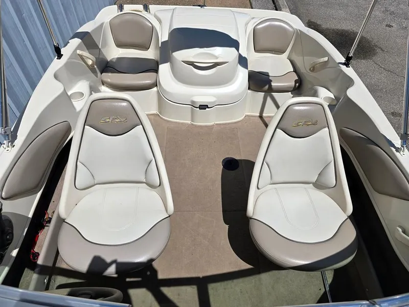 Slide: The Image of 2003 Sea Ray 176 SRX BR boat interior with white and beige seating arrangement. - 5