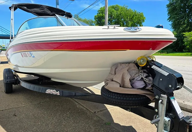Slide: The Image of 2003 Sea Ray 176 SRX BR boat on trailer, parked outdoors on a sunny day. - 6