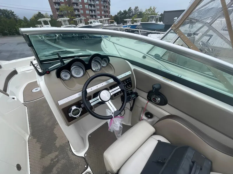 Slide: The Image of 2012 Sea Ray 260 Sundeck boat interior with steering wheel and dashboard controls. - 14