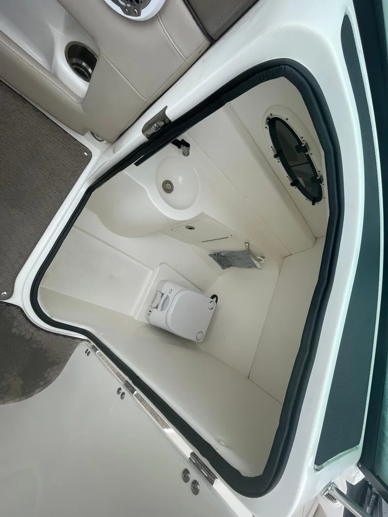 Slide: The Image of 2012 Sea Ray 260 Sundeck boat interior with compact bathroom and toilet. - 18