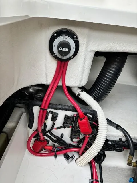 Slide: The Image of 2012 Sea Ray 260 Sundeck battery compartment with wiring and connections. - 24