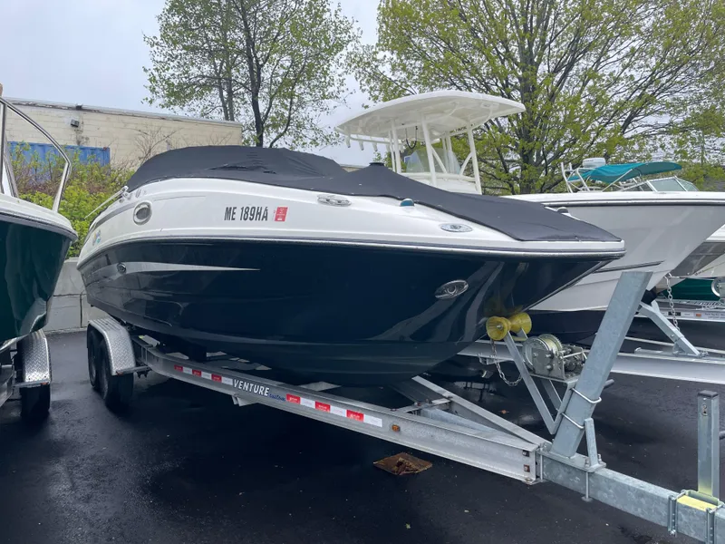 Slide: The Image of 2012 Sea Ray 260 Sundeck boat on trailer, covered and parked outdoors. - 4
