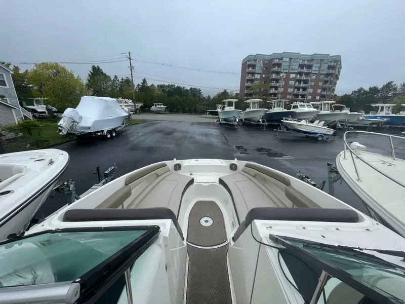 Slide: The Image of 2012 Sea Ray 260 Sundeck boat in a marina with other boats and a building. - 9