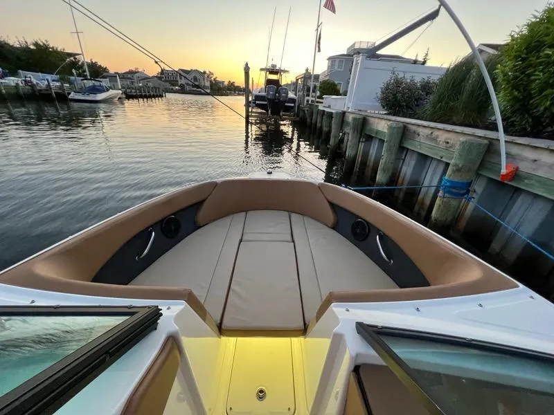 Slide: The Image of 2018 Sea Ray SPX 230 Outboard boat docked at sunset, featuring spacious seating. - 12