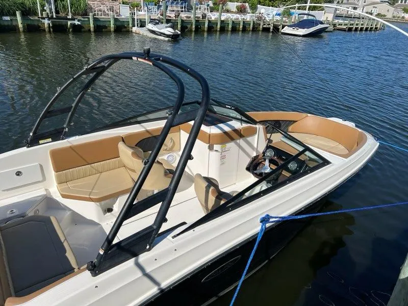 Slide: The Image of 2018 Sea Ray SPX 230 Outboard boat docked in a marina. - 4