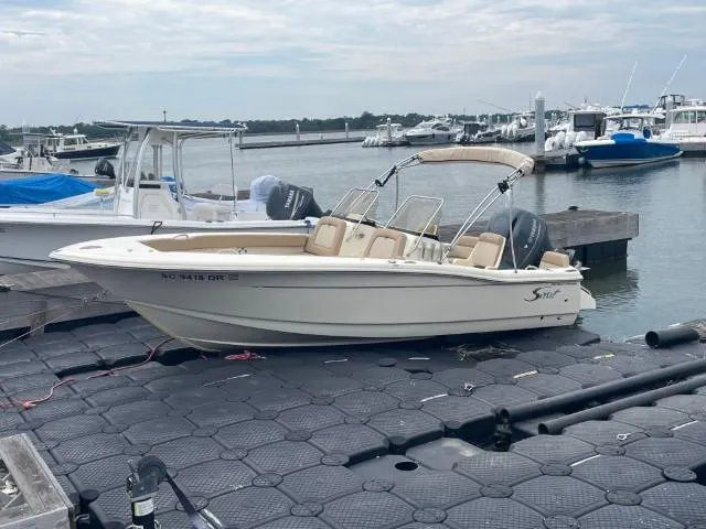 Slide: The Image of 2022 Scout Sport 195 Dorado boat docked at marina with other vessels. - 0