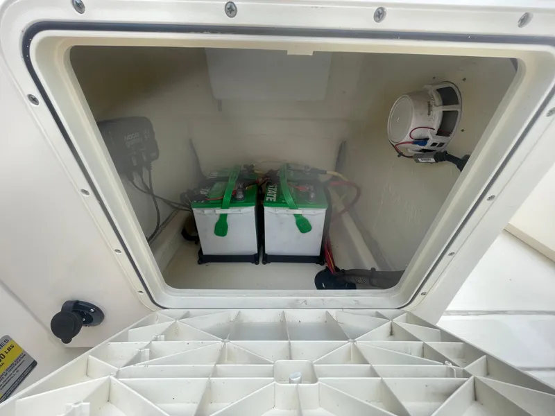 Slide: The Image of 2022 Scout Sport 195 Dorado battery compartment with dual batteries and wiring. - 10