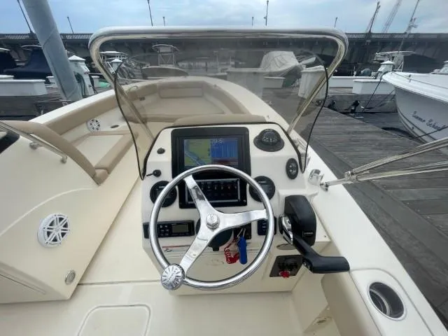 Slide: The Image of 2022 Scout Sport 195 Dorado boat dashboard with steering wheel and navigation display. - 11
