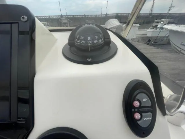 Slide: The Image of Compass and controls on 2022 Scout Sport 195 Dorado boat dashboard. - 14