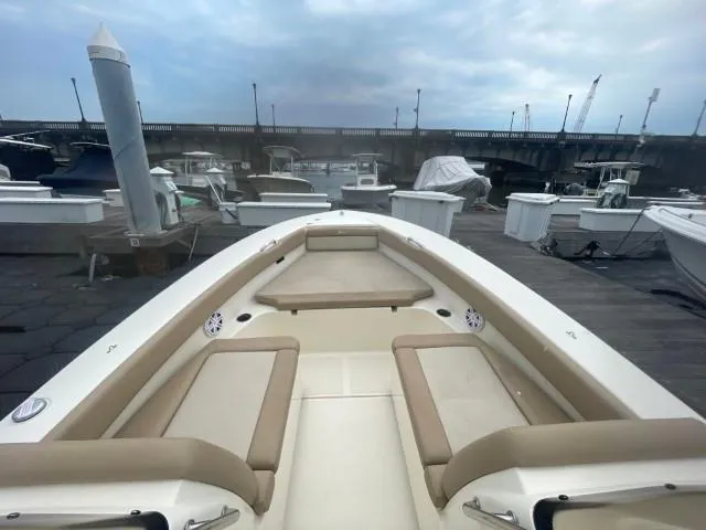 Slide: The Image of 2022 Scout Sport 195 Dorado boat docked at marina under cloudy sky. - 6
