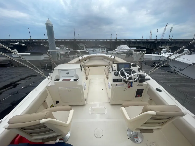 Slide: The Image of 2022 Scout Sport 195 Dorado boat interior with dual helm seats and steering wheel. - 9